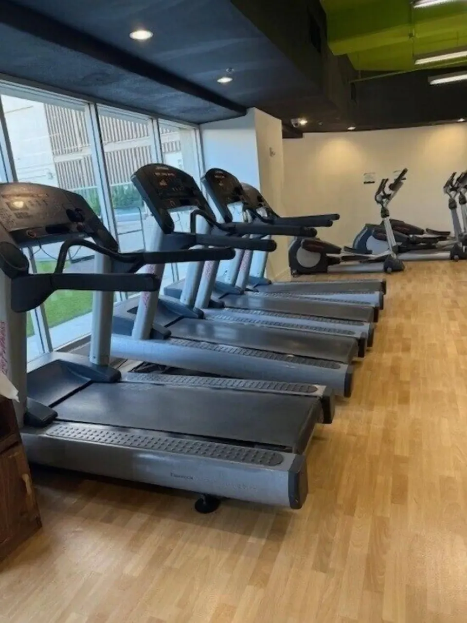 Rows of treadmills and cardio machines in the fitness room at Ala Moana Hotel.