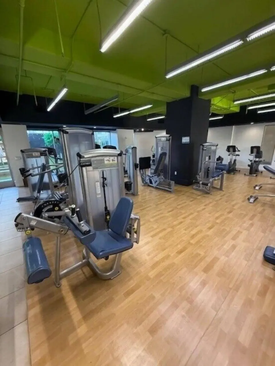 Fitness room with weight machines and wood-look flooring at Ala Moana Hotel.
