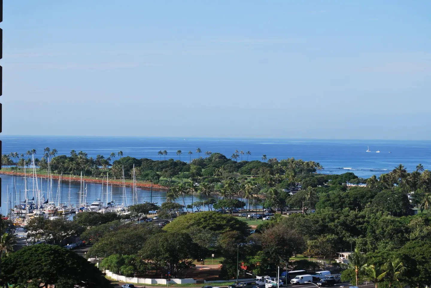 Marina, park, and ocean view from Ala Moana Hotel with sailboats and palm trees.