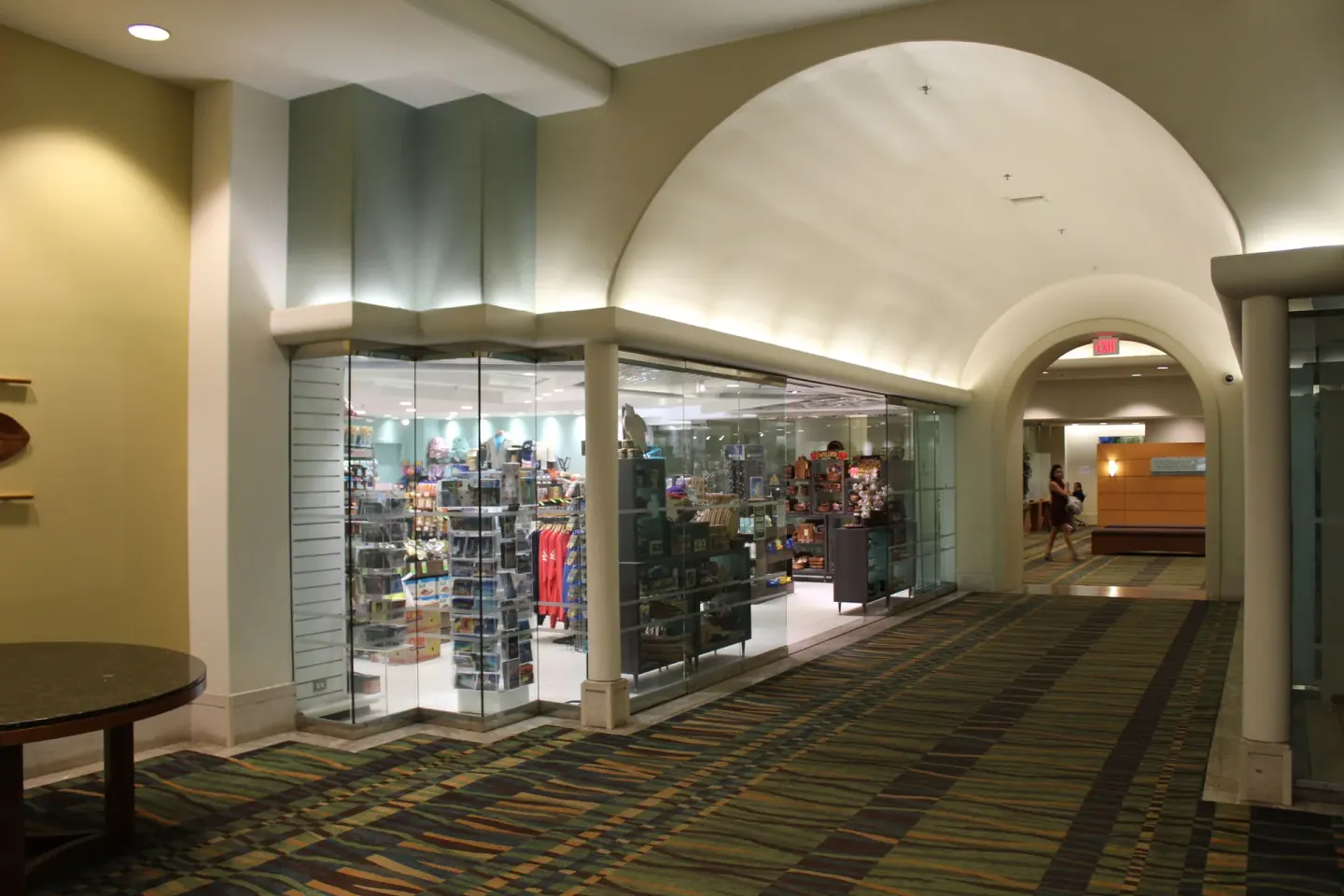 Glass-fronted retail shop along an arched corridor at Ala Moana Hotel.