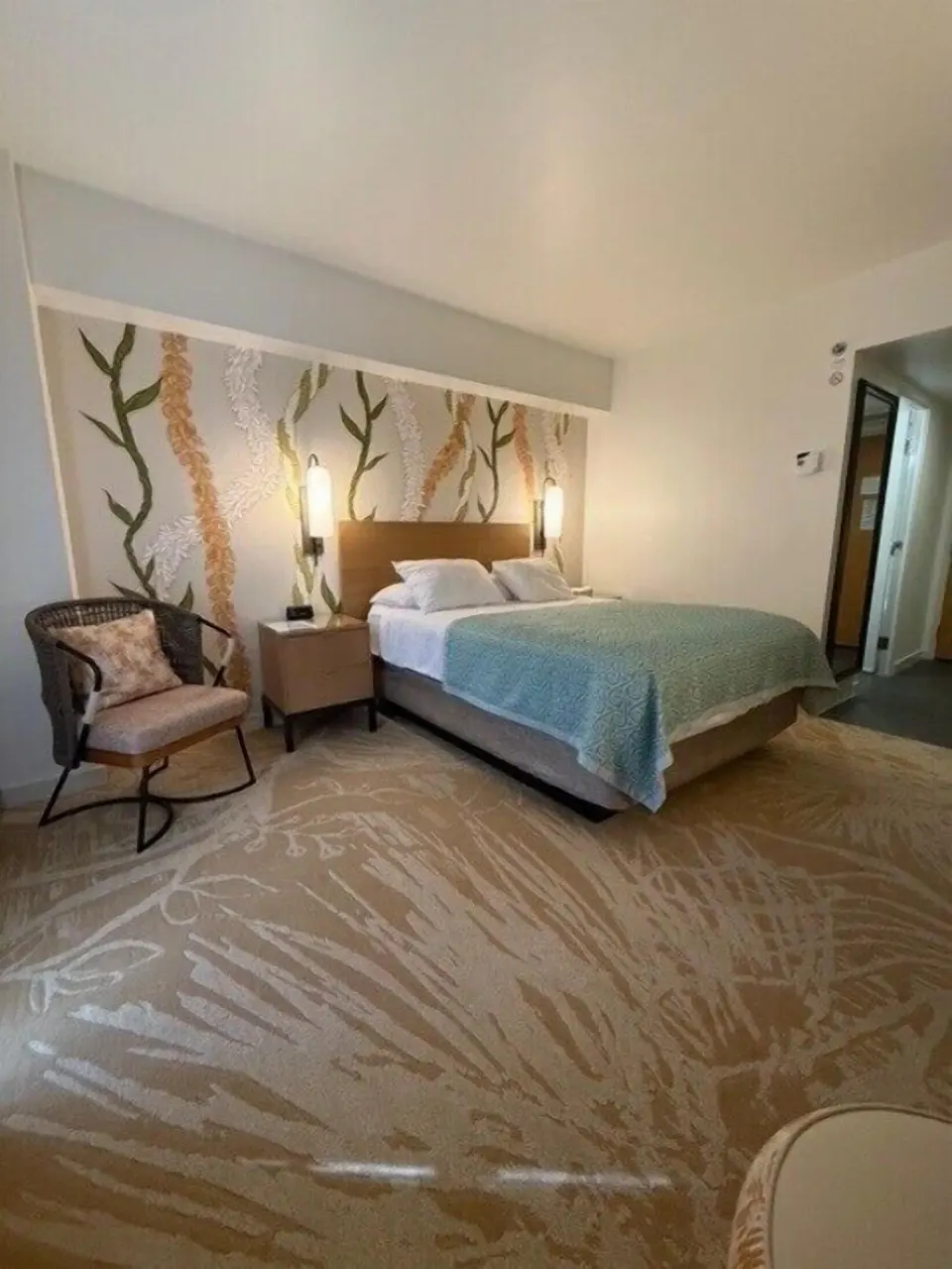 Standard Room king bed with accent chair and entry area at Ala Moana Hotel.