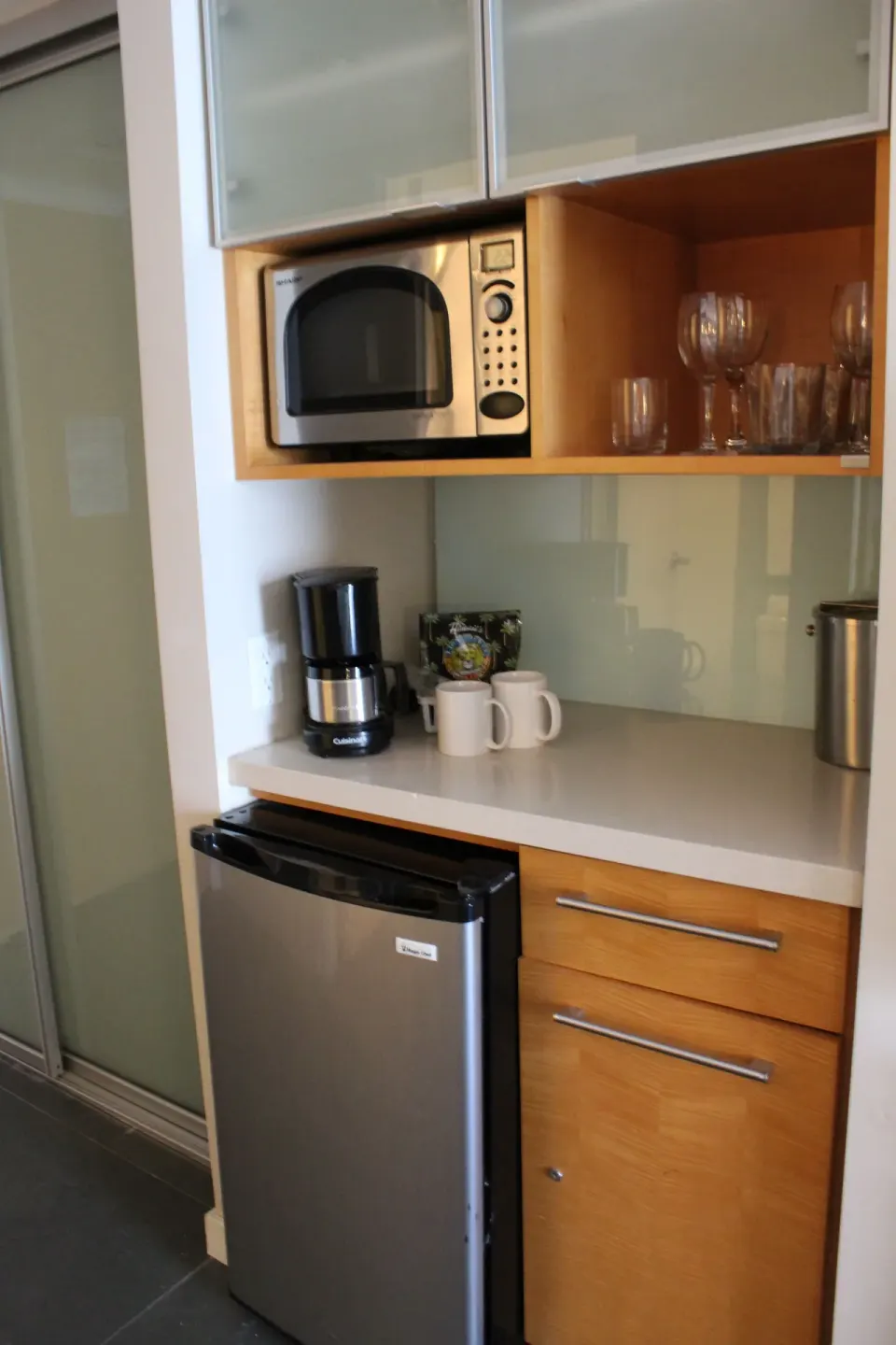 Standard Room refreshment cabinet with mini fridge and coffee setup at Ala Moana Hotel.