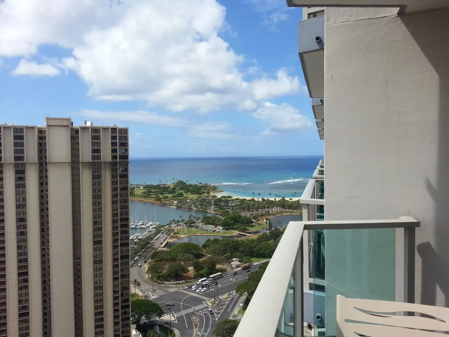 Ocean, lagoon, marina, and city streets seen from a balcony at Ala Moana Hotel.