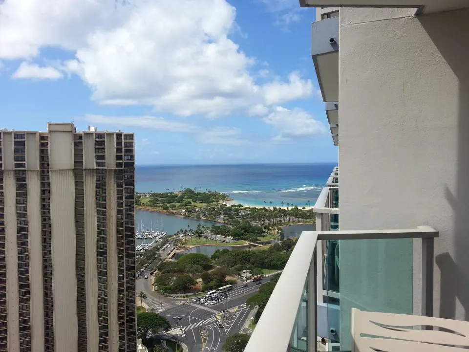Ocean, lagoon, marina, and city streets seen from a balcony at Ala Moana Hotel.