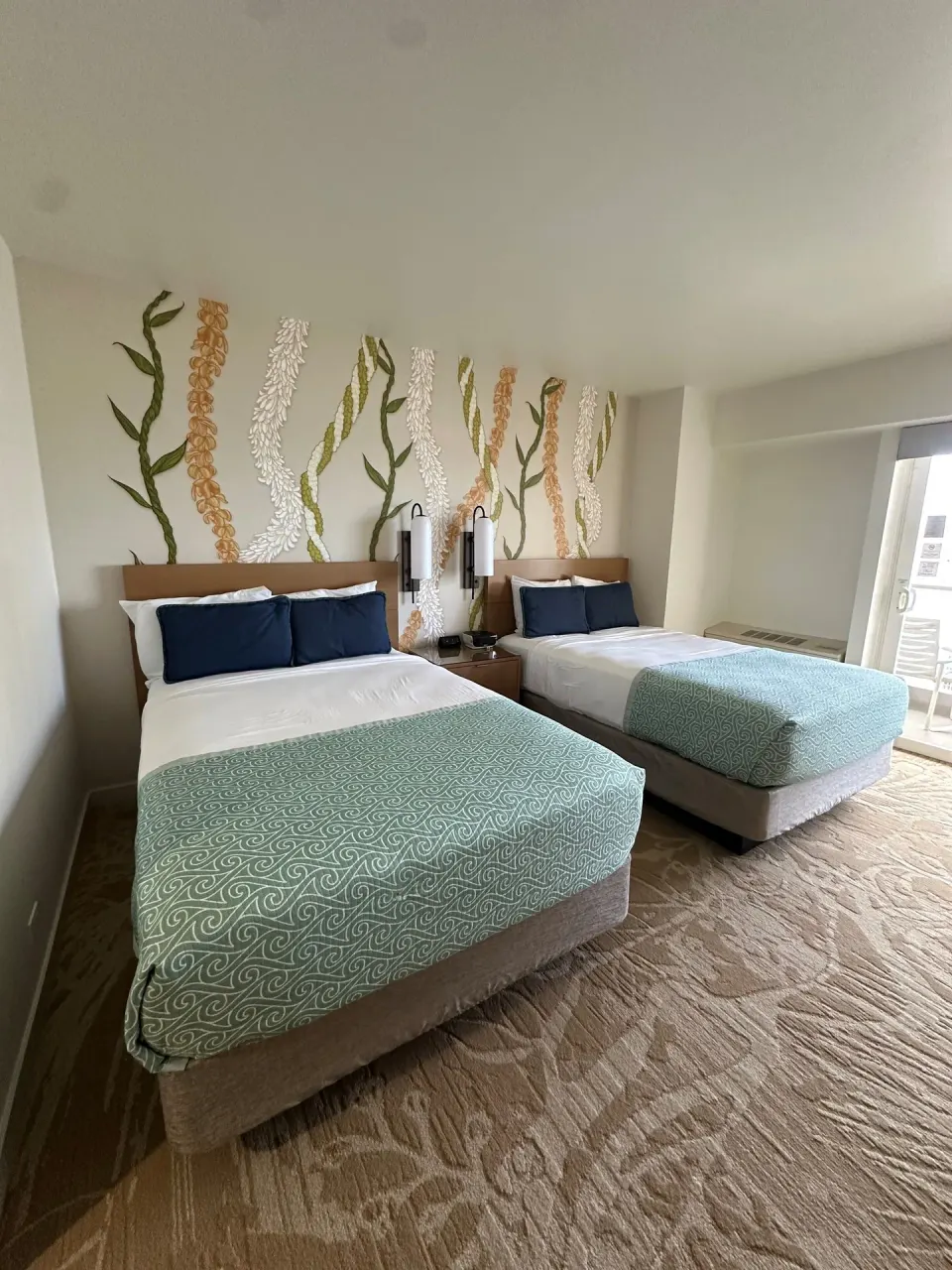 Two double beds in a Superior Ocean View room at Ala Moana Hotel beside a balcony door.