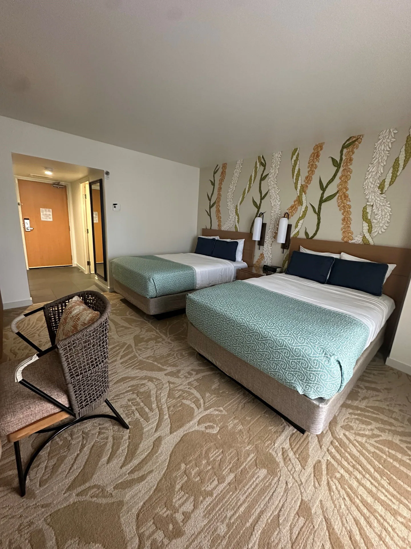 Two double beds in a Superior Ocean View room at Ala Moana Hotel, with floral wall art and seating.