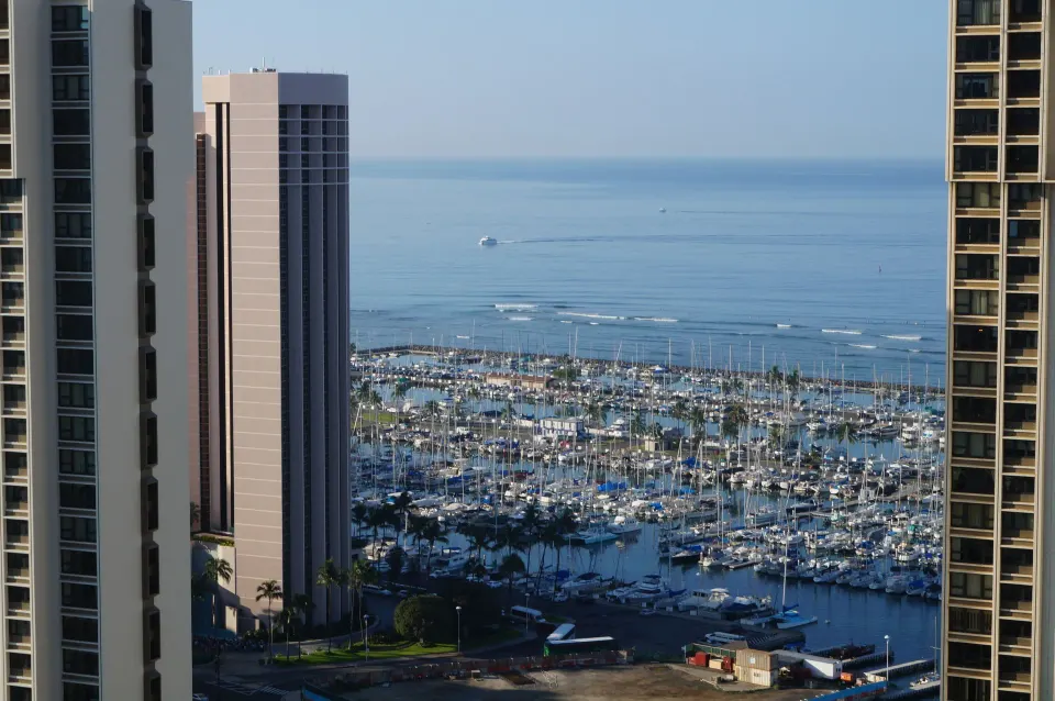 Marina and ocean view between high-rises from Ala Moana Hotel's Waikiki Tower.