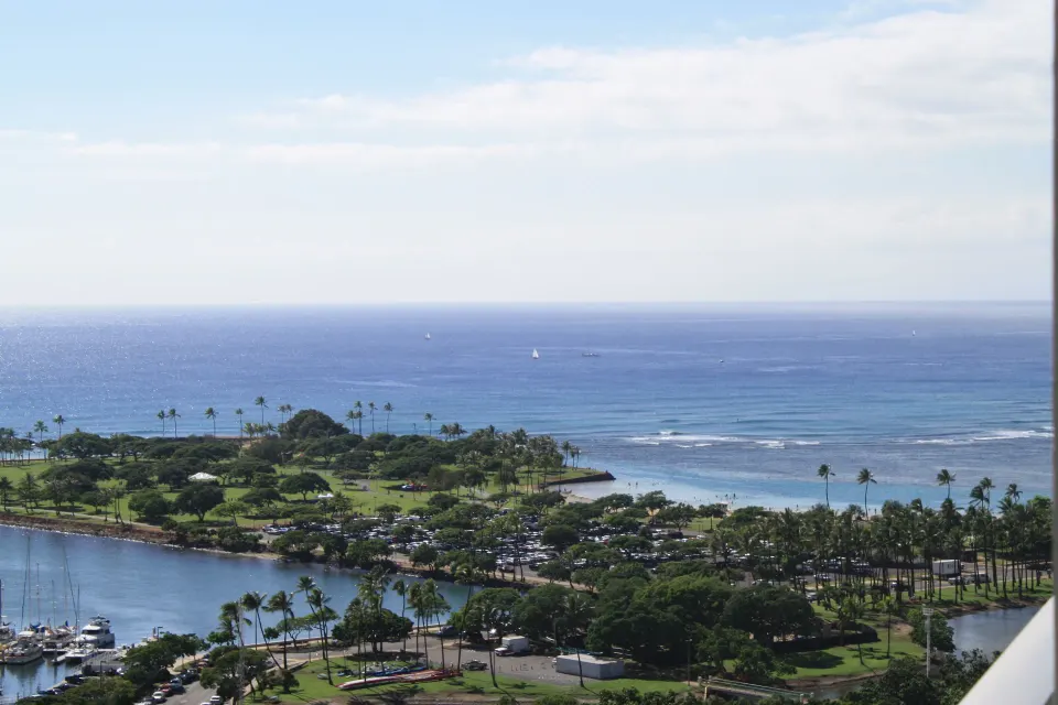 Park, shoreline, and blue ocean view from a Superior Room at Ala Moana Hotel.