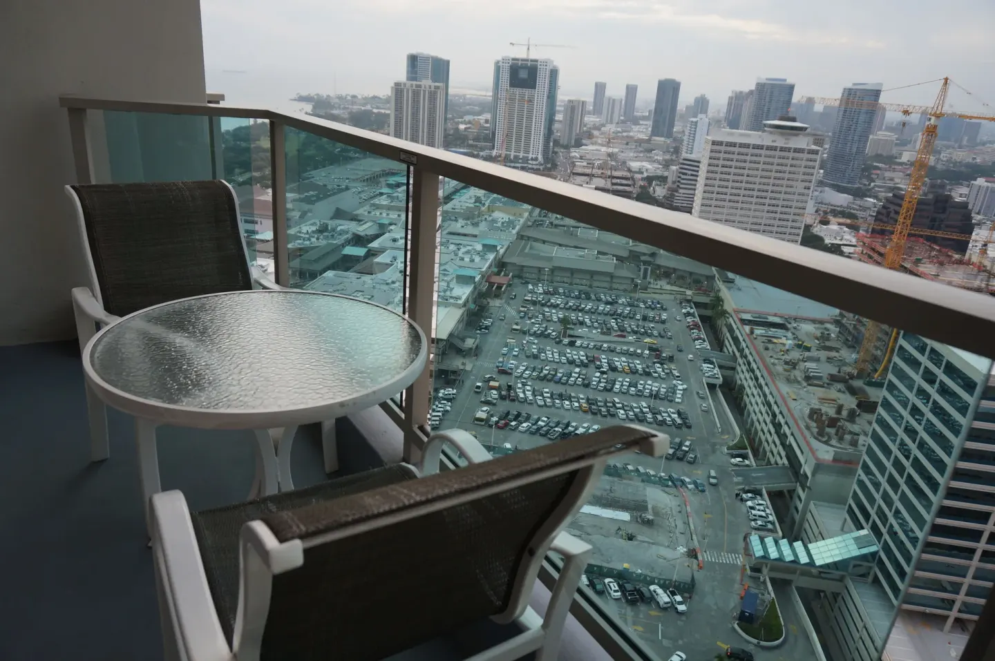 Superior Room balcony table and chairs overlooking Honolulu at Ala Moana Hotel.