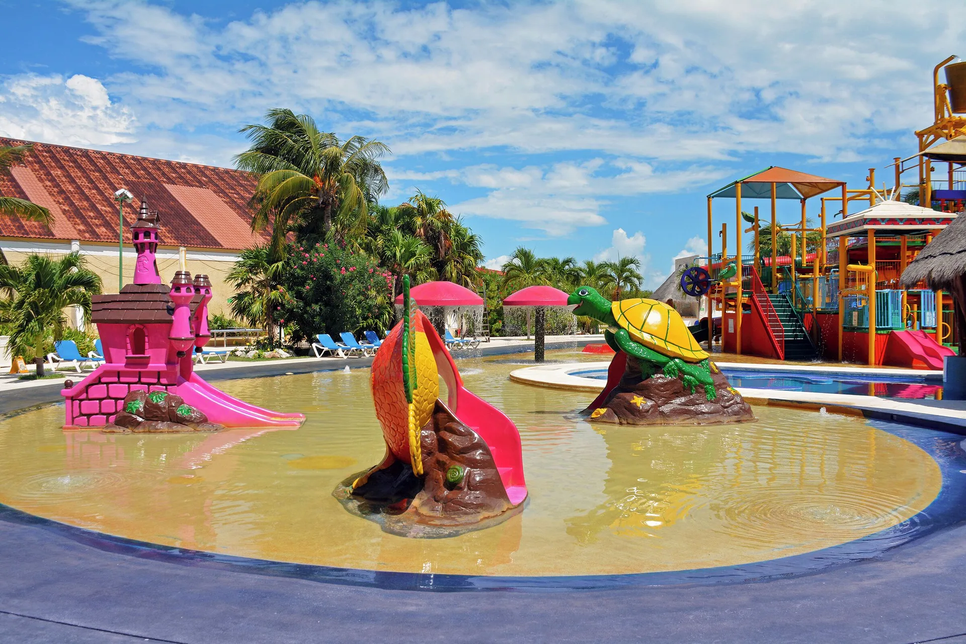 Children’s splash pool with castle and animal slides at All Ritmo Cancun Resort & Water Park.