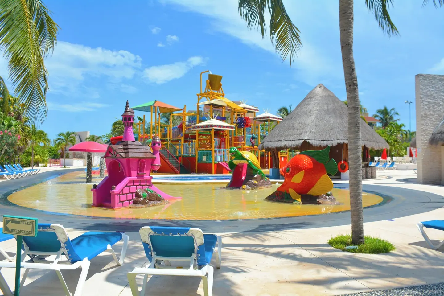 Children's splash pool with castle and fish figures at All Ritmo Cancun Resort & Water Park.