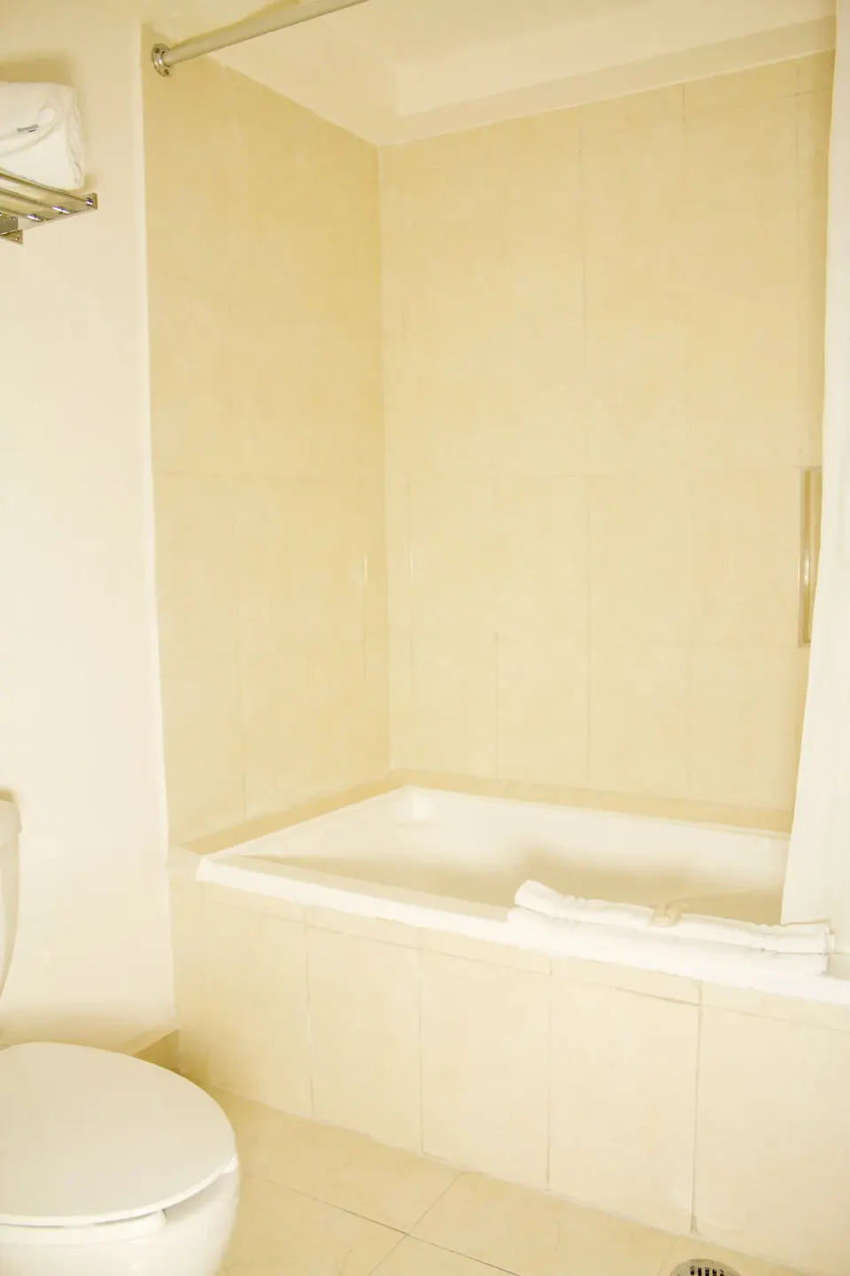Guest bathroom tub and shower area with tile surround at All Ritmo Cancun Resort & Water Park.
