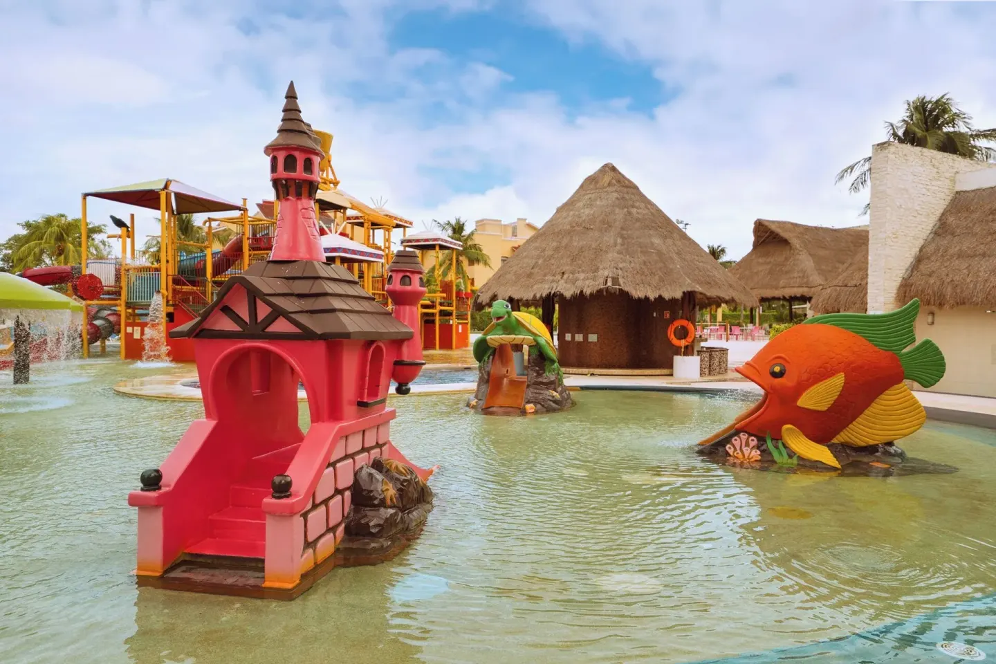Shallow splash pool with castle and fish features at All Ritmo Cancun Resort & Water Park.