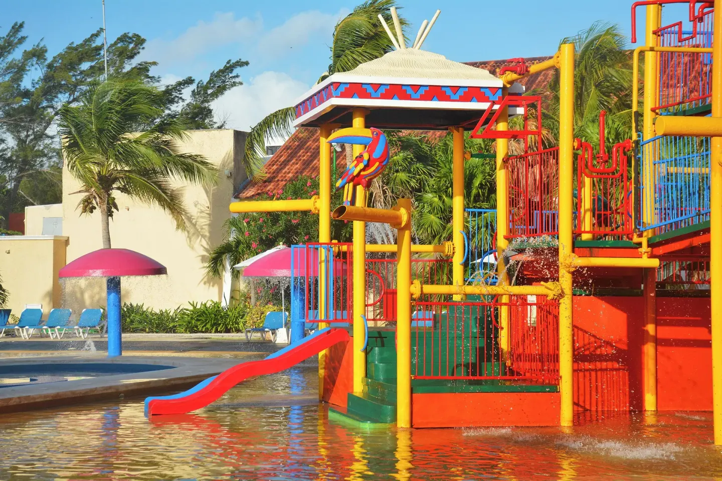 Colorful water play structure and slide at All Ritmo Cancun Resort & Water Park.