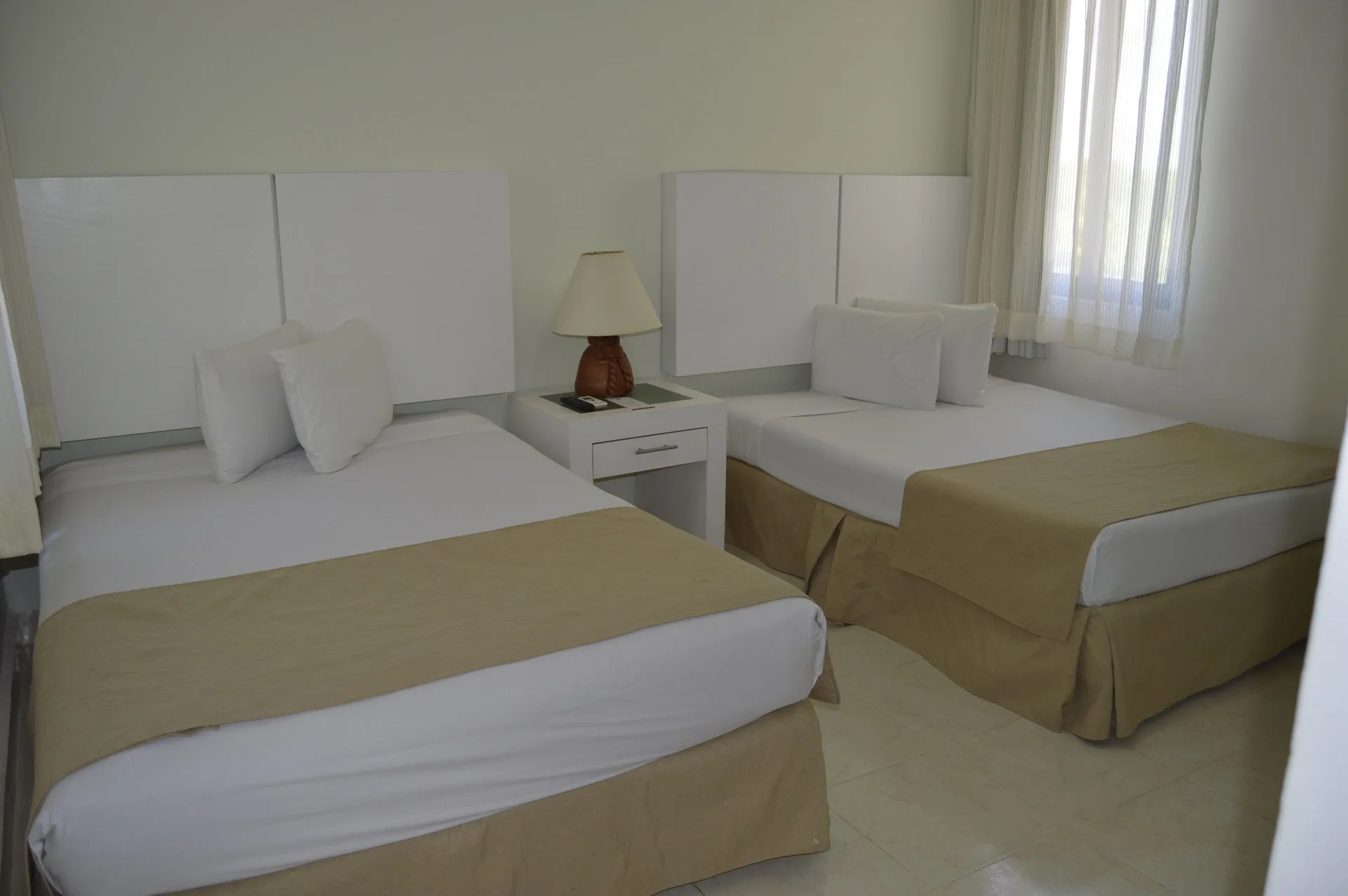 Master Suite Garden View bedroom with two beds at All Ritmo Cancun Resort & Water Park.