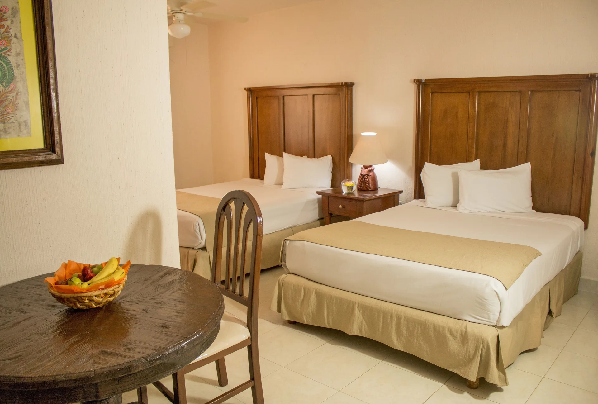 Standard room with two beds and a round dining table at All Ritmo Cancun Resort & Water Park.