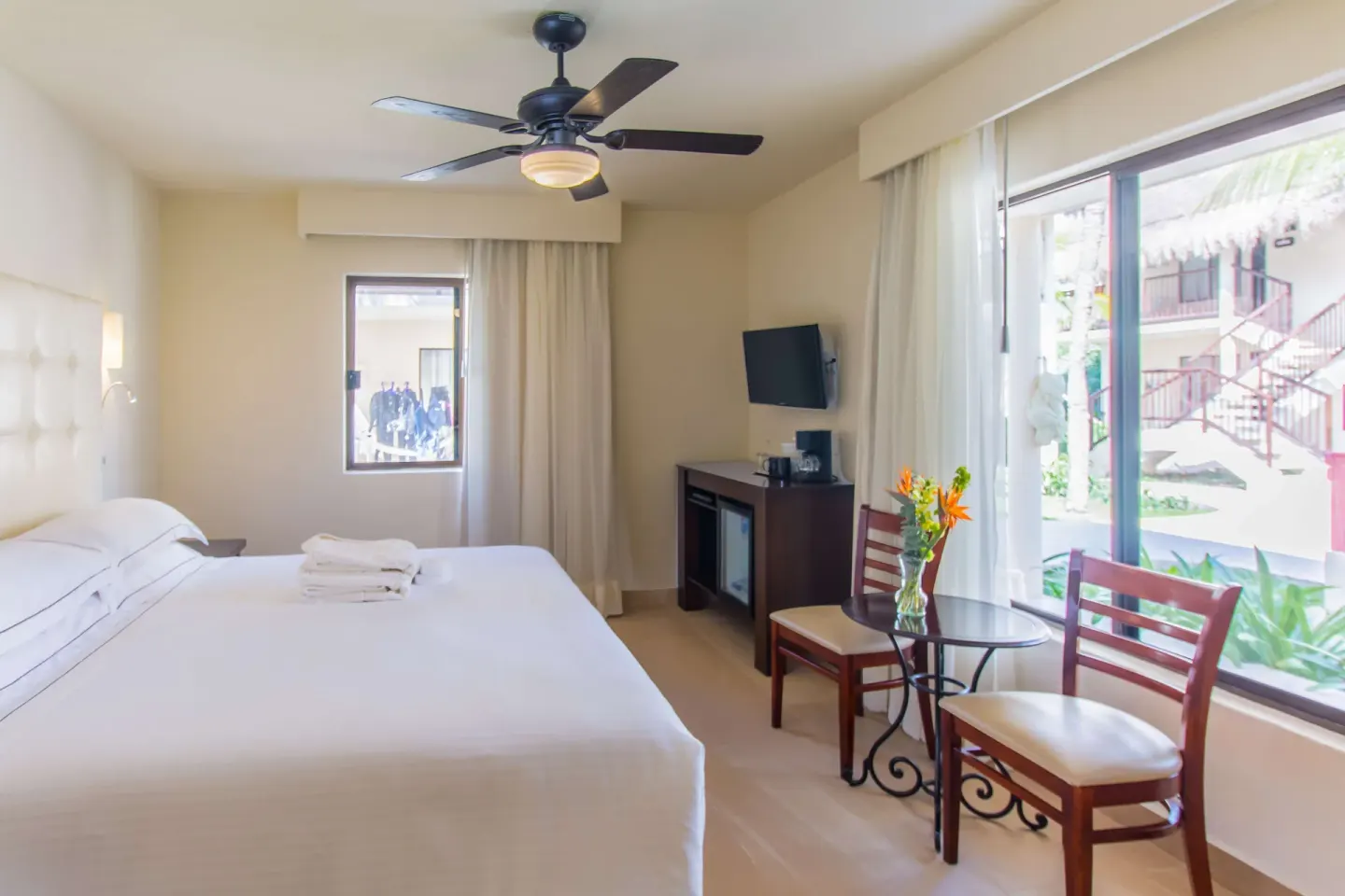 Superior Premium Level Room with king bed, window seating, and large exterior window at Allegro Cozumel.