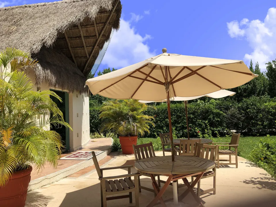 Private patio with umbrella seating outside a Superior Premium Level Room at Allegro Cozumel.