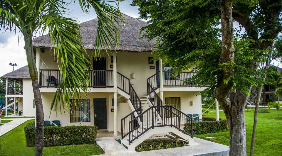 Superior Room building with balconies and thatched roof at Allegro Cozumel.