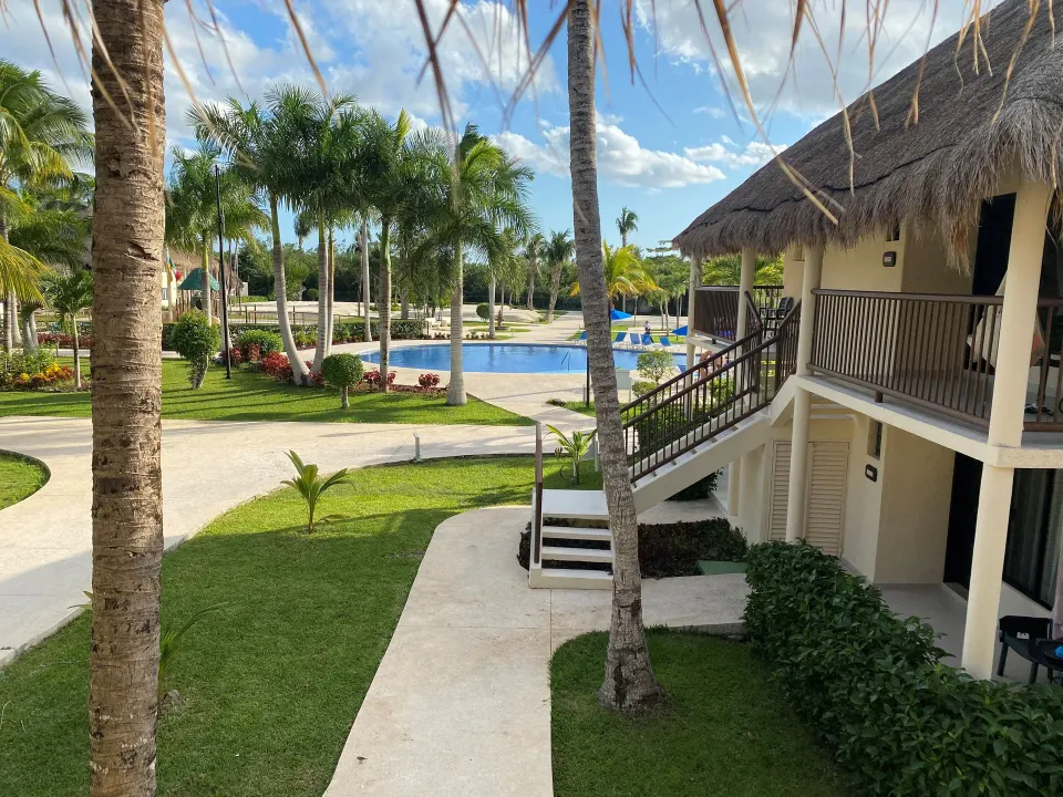 Superior Room exterior near pool and palm-lined paths at Allegro Cozumel.