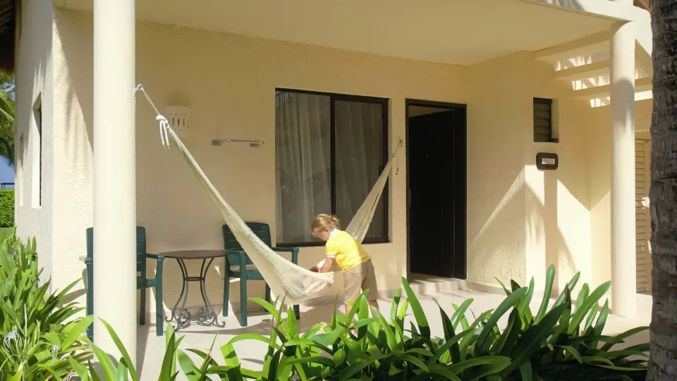 Superior Room terrace with hammock and outdoor table at Allegro Cozumel.
