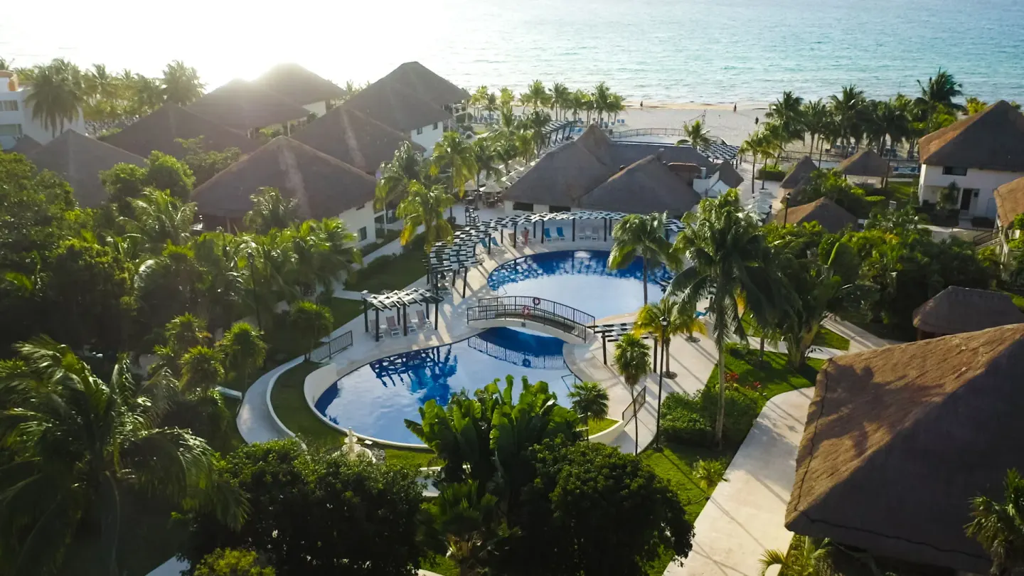 Aerial view of a pool courtyard near the beach at Allegro Playacar.