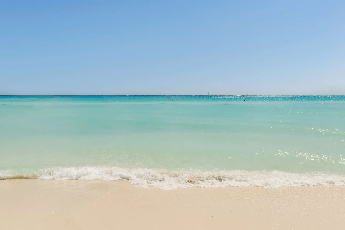 Turquoise water meets the sandy beach at Allegro Playacar.