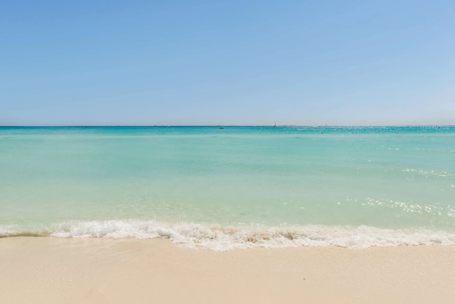 Turquoise water meets the sandy beach at Allegro Playacar.