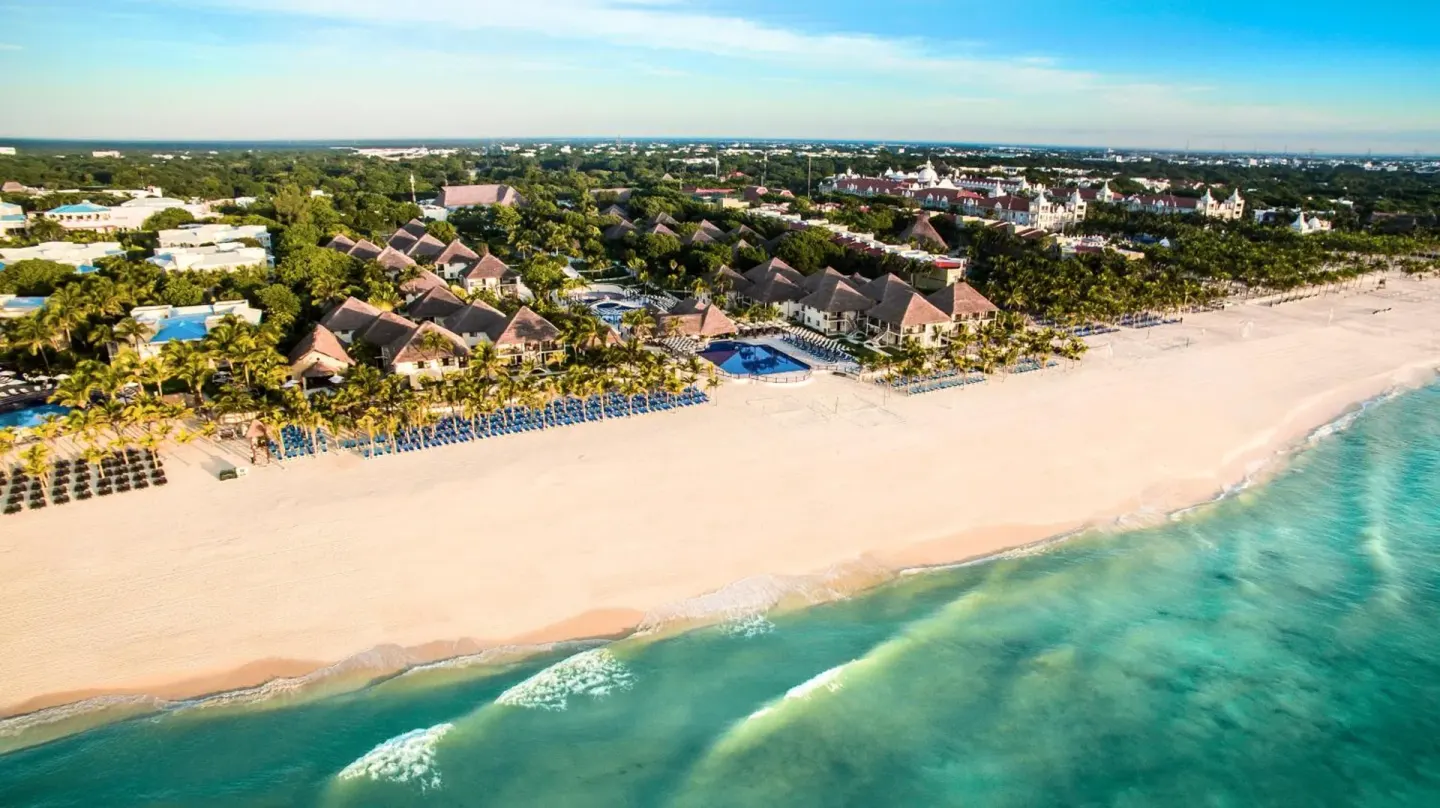 Wide aerial view of Allegro Playacar along a white-sand beach and turquoise sea.
