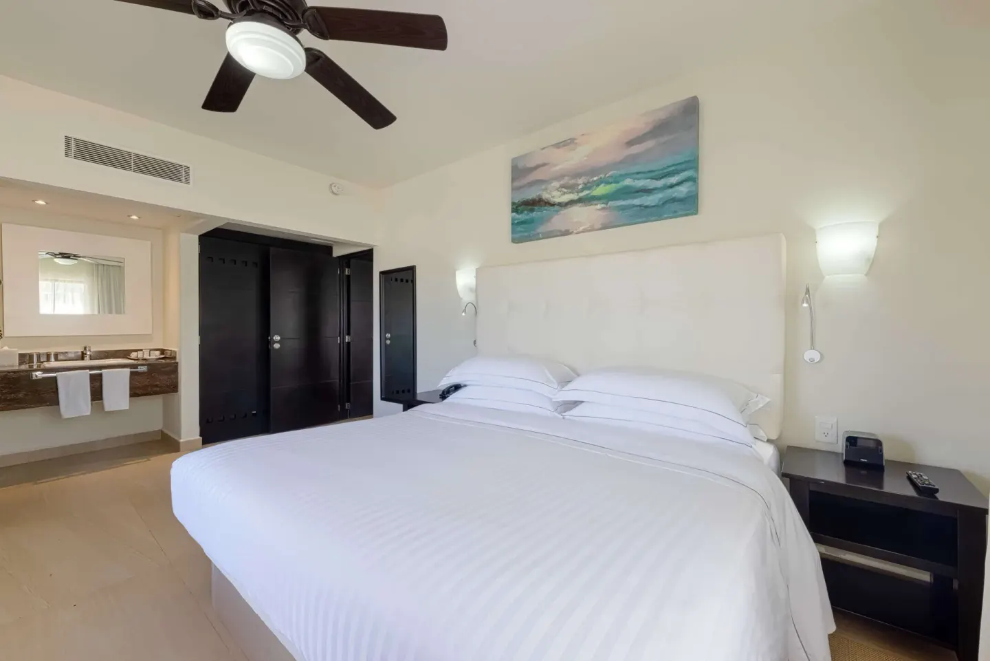Superior Room with king bed, open vanity, and dark wardrobe at Allegro Playacar.