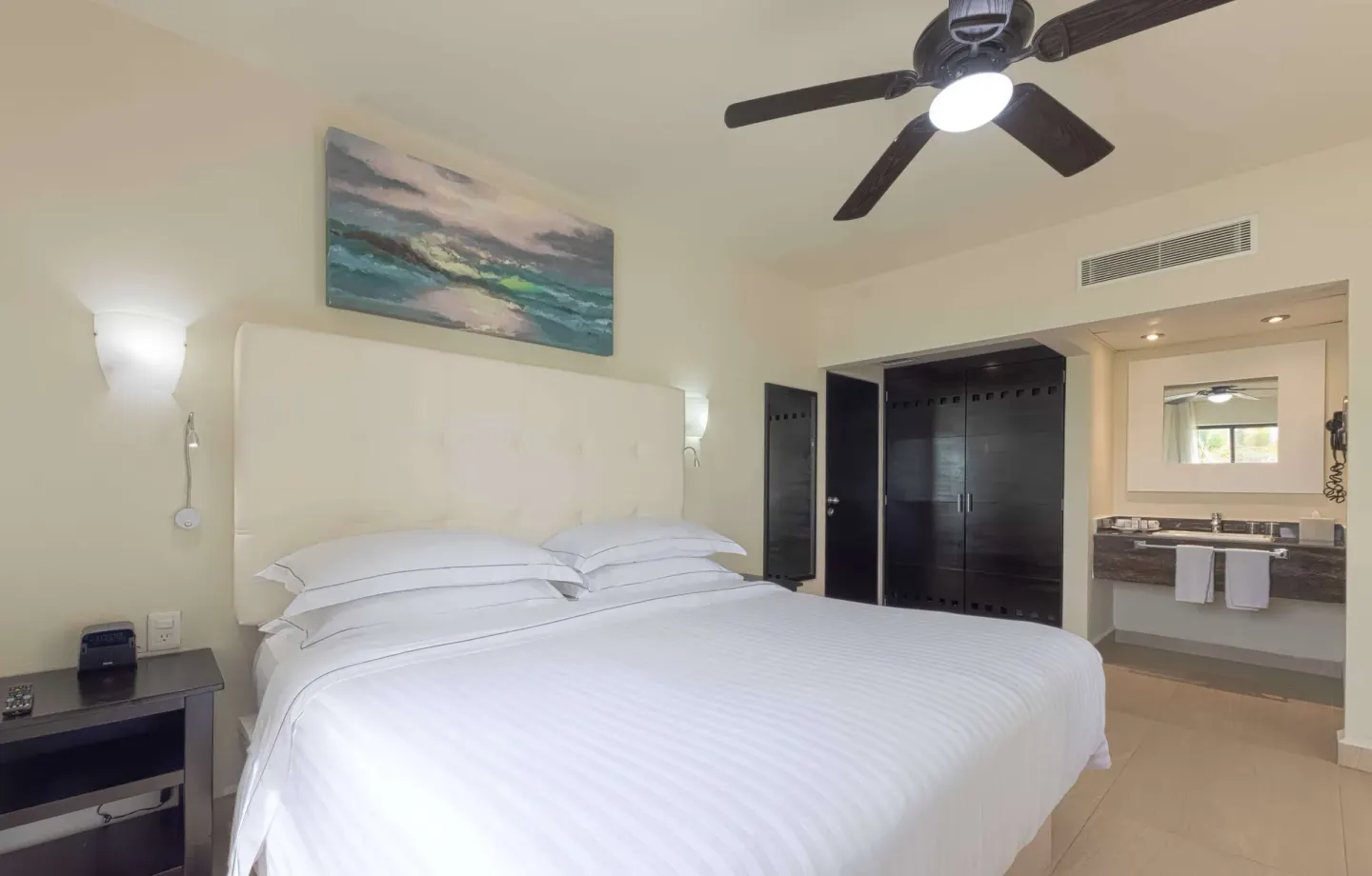 Superior Room king bed with vanity, wardrobe, and ceiling fan at Allegro Playacar.