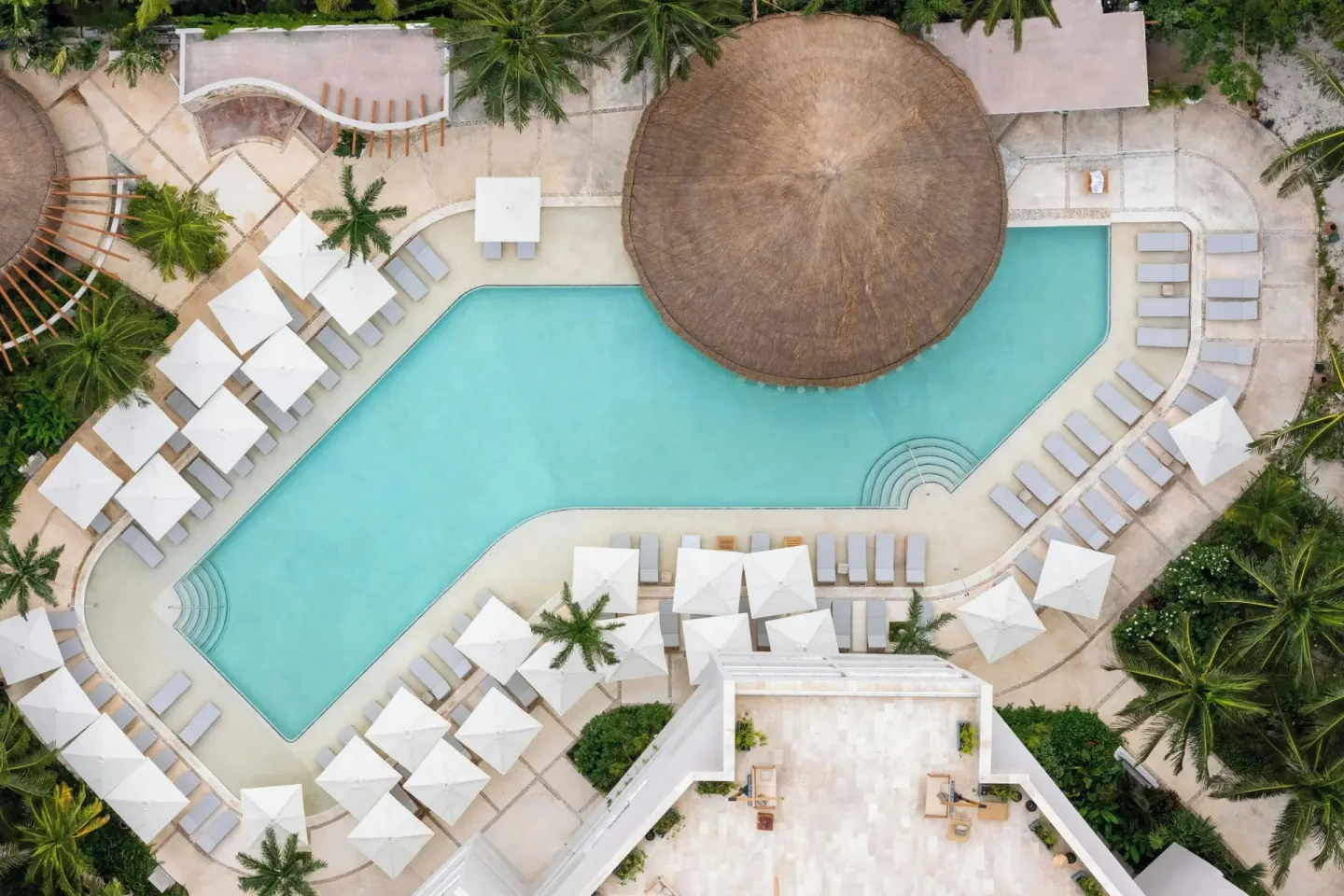 Aerial view of the main pool and umbrellas at Almare, a Luxury Collection Resort, Isla Mujeres.