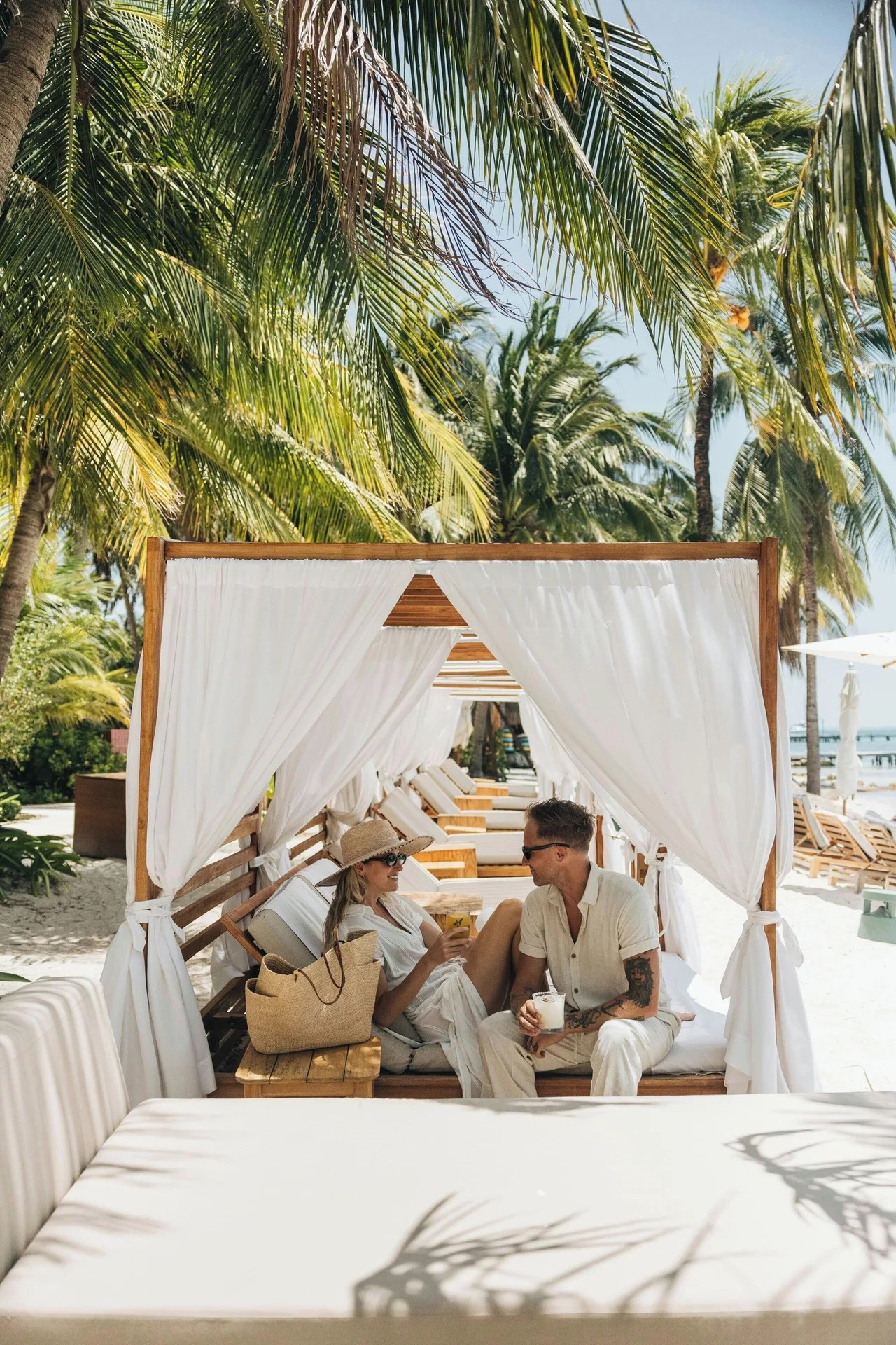 Couple sitting in a beachfront cabana at Almare, a Luxury Collection Resort, Isla Mujeres.