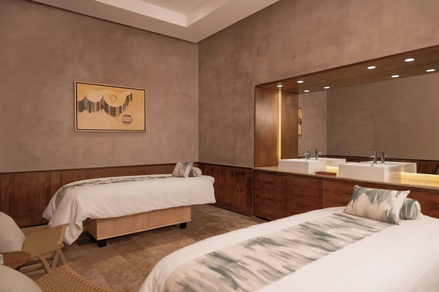 A spa treatment room with two massage beds is shown at Almare, a Luxury Collection Resort, Isla Mujeres.