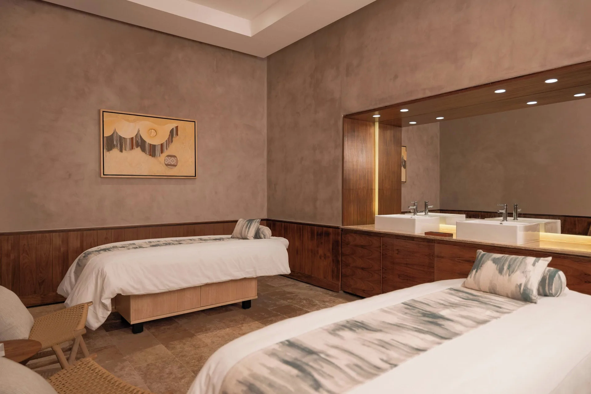 A spa treatment room with two massage beds is shown at Almare, a Luxury Collection Resort, Isla Mujeres.