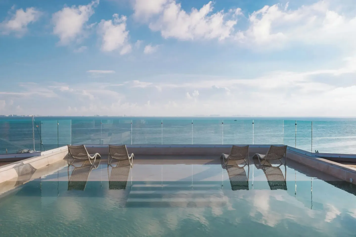 Infinity-edge pool with submerged loungers and sea views at Almare, a Luxury Collection Resort, Isla Mujeres.