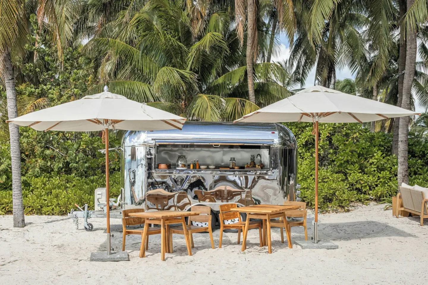 Shiny beach food truck with umbrella seating at Almare, a Luxury Collection Resort, Isla Mujeres.