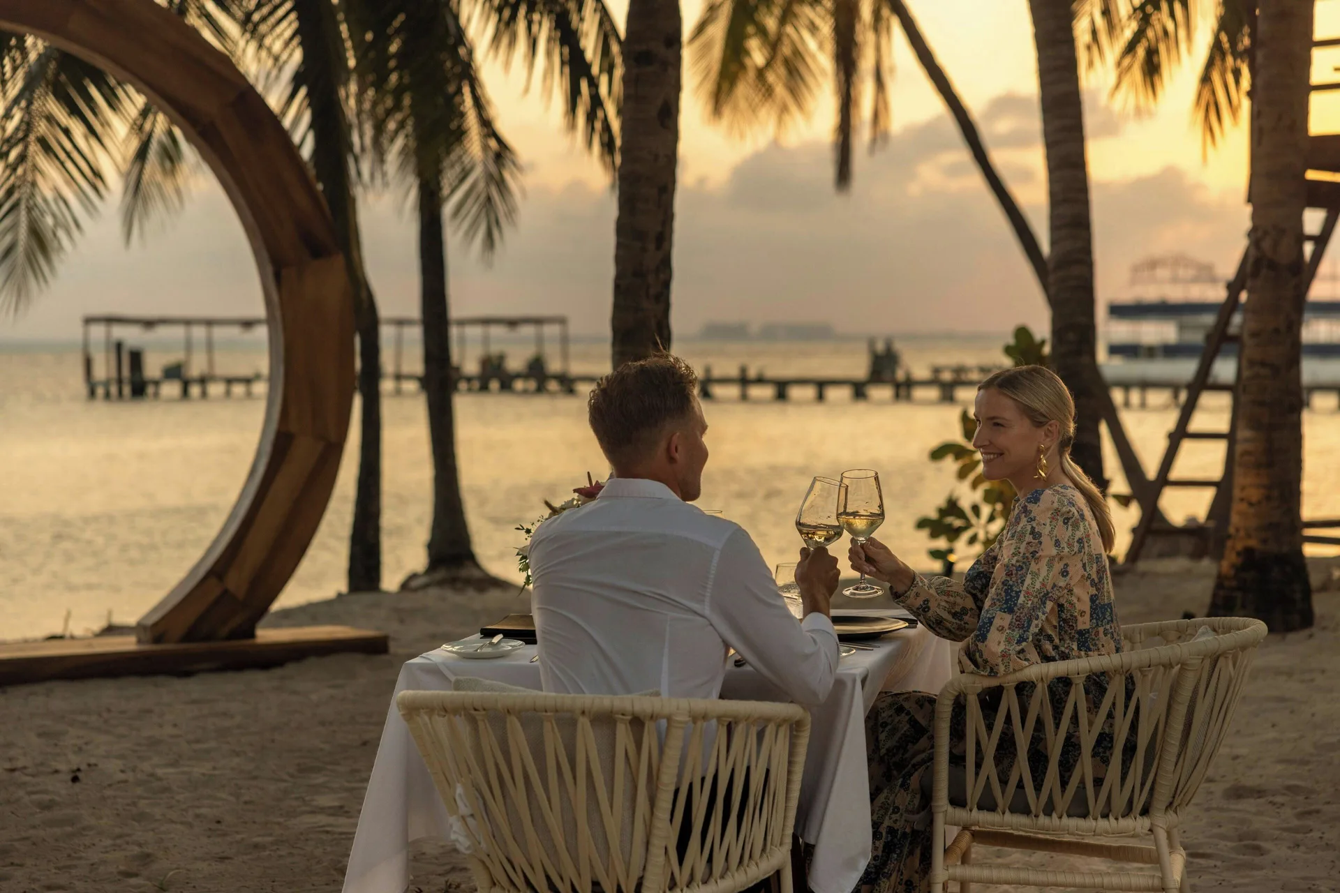 Couple dining on the beach at sunset at Almare, a Luxury Collection Resort, Isla Mujeres.