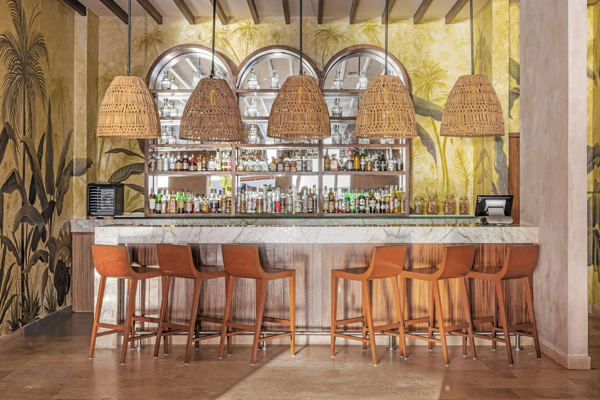 Bar with woven lamps and bottle shelves at Almare, a Luxury Collection Resort, Isla Mujeres.