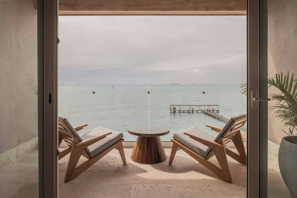 Oceanfront balcony with two chairs and sea view at Almare, a Luxury Collection Resort, Isla Mujeres.