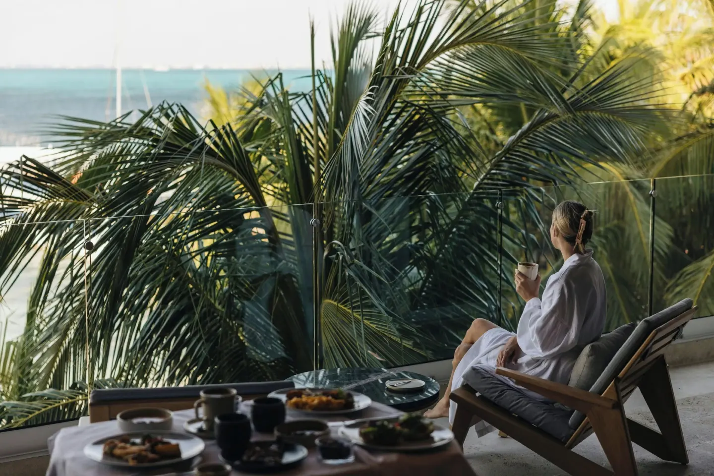 Grand Suite balcony breakfast with ocean and palms at Almare, a Luxury Collection Resort, Isla Mujeres.