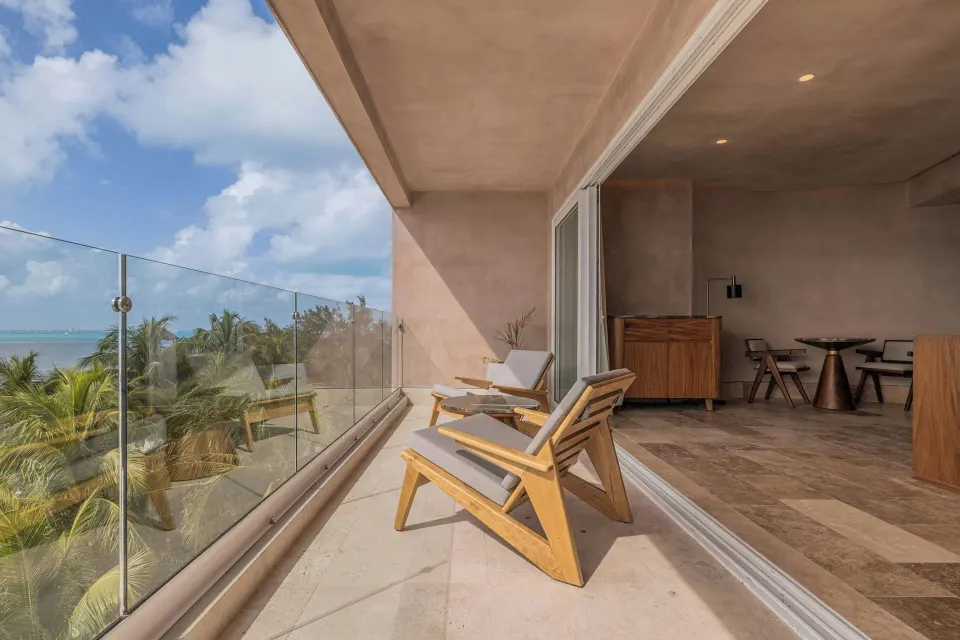 Grand Suite oceanfront balcony with lounge chairs at Almare, a Luxury Collection Resort, Isla Mujeres.