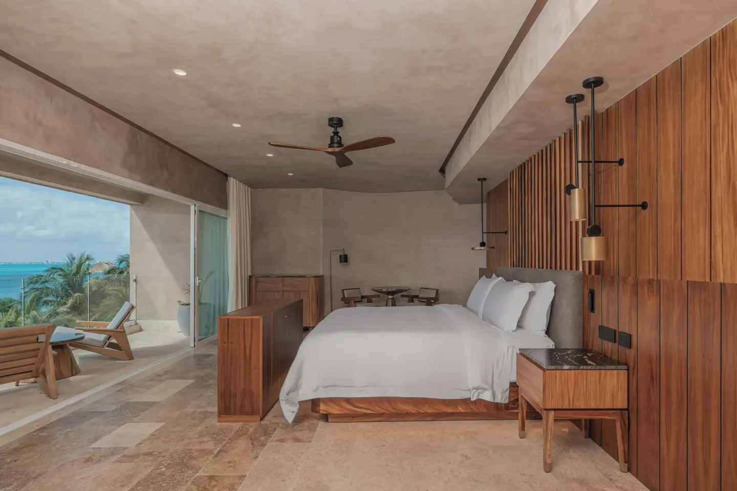 Grand Suite king bed beside an oceanfront balcony at Almare, a Luxury Collection Resort, Isla Mujeres.