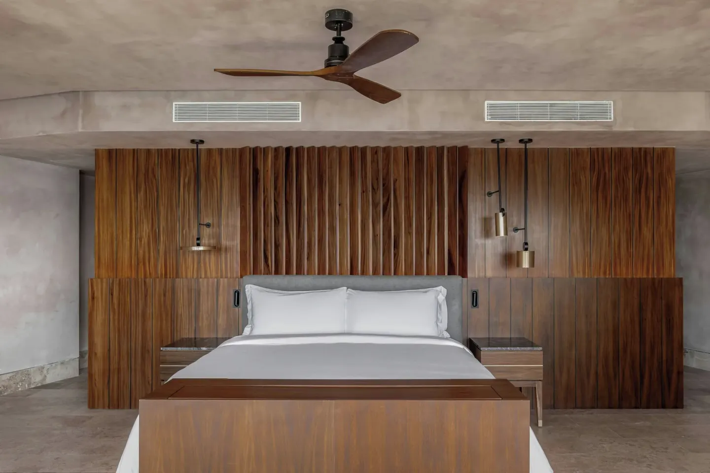 Grand Suite king bed and wood headboard wall at Almare, a Luxury Collection Resort, Isla Mujeres.