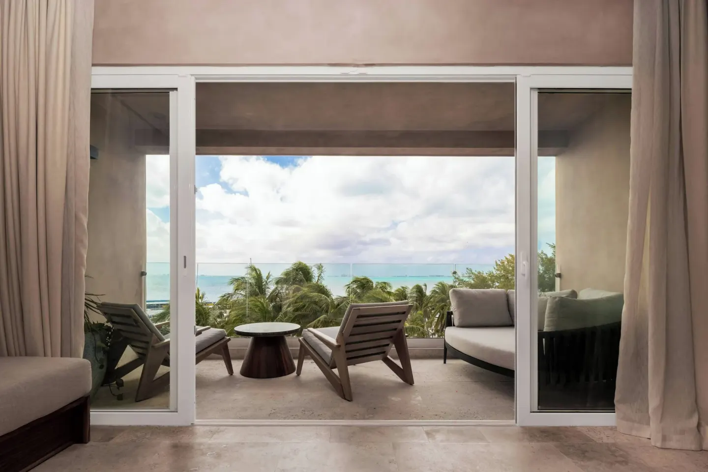 Junior Suite balcony with lounge seating and ocean view at Almare, a Luxury Collection Resort, Isla Mujeres.