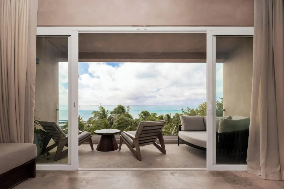 Junior Suite balcony with lounge seating and ocean view at Almare, a Luxury Collection Resort, Isla Mujeres.