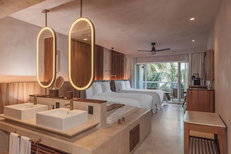 Standard Room Balcony with twin vanities, tub, and two beds at Almare, Isla Mujeres.