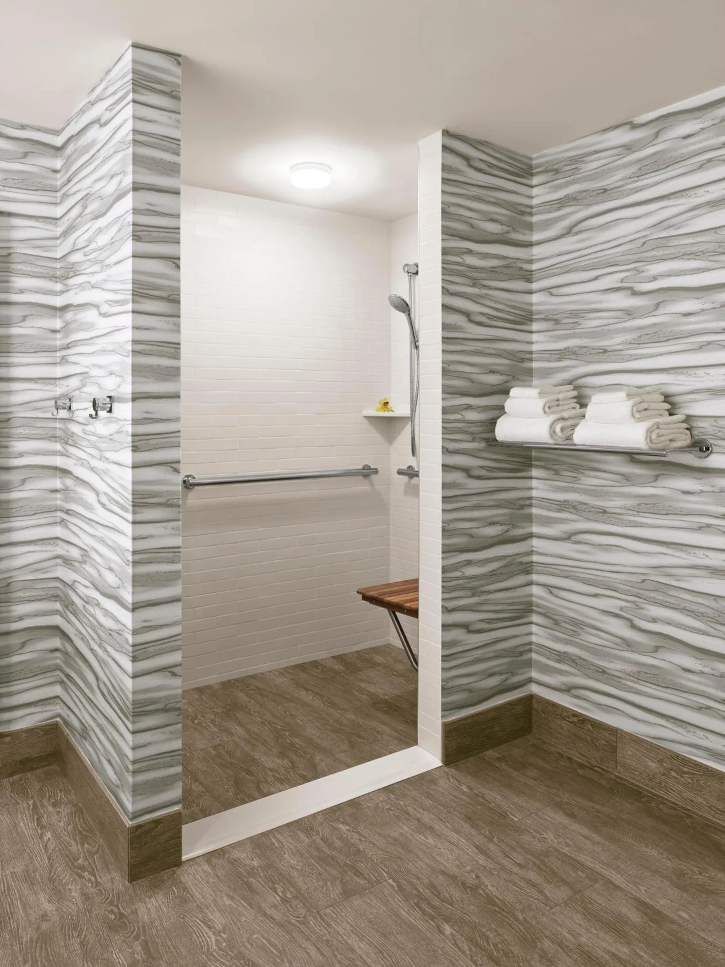 Accessible shower area with towel shelf at 'Alohilani Resort Waikiki Beach.