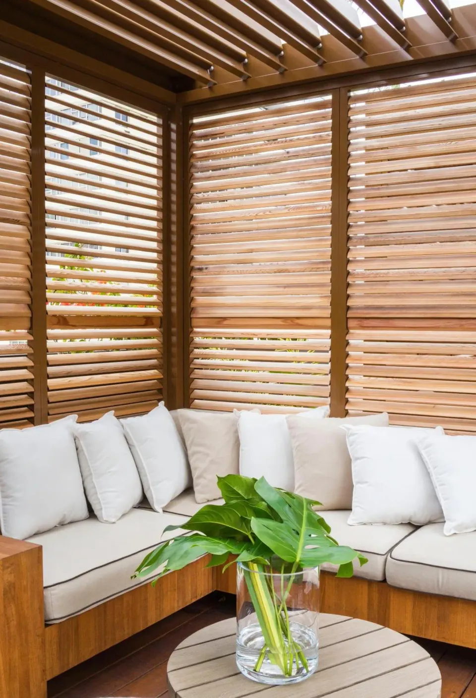 Covered cabana seating with wood slat walls at 'Alohilani Resort Waikiki Beach.