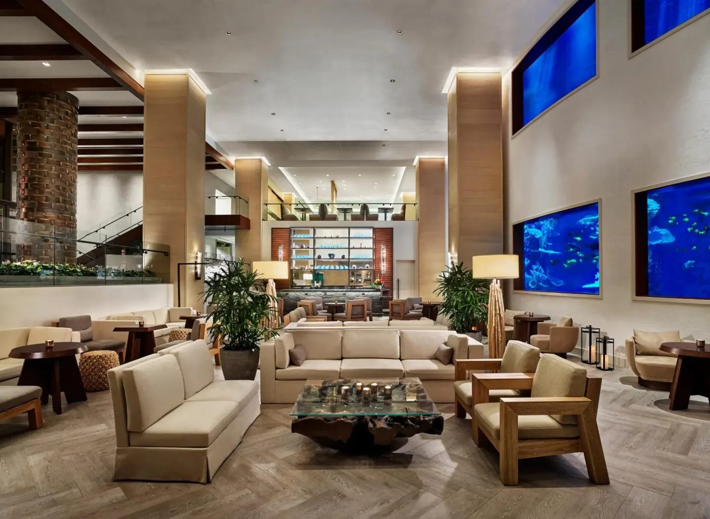 Lobby lounge with aquarium wall displays at 'Alohilani Resort Waikiki Beach.
